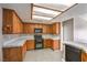 Functional kitchen with wood cabinets, tiled countertops, and modern appliances at , Pahrump, NV 89061