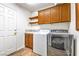 Functional laundry room with washer, dryer, storage cabinets, utility sink, and door at , Pahrump, NV 89061