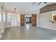 Open-concept living room with neutral paint, tile floors, and stylish barn doors at , Pahrump, NV 89061
