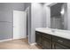 Bathroom with a dark brown vanity with white countertop and light wood colored floors at 10211 Red Pueblo Pl # 203, Las Vegas, NV 89144