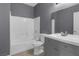 Bathroom featuring a shower-tub combo, a gray vanity, and a large mirror at 10211 Red Pueblo Pl # 203, Las Vegas, NV 89144