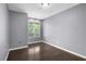 Cozy bedroom featuring neutral walls, wood floors, and a bright window at 10211 Red Pueblo Pl # 203, Las Vegas, NV 89144