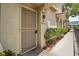 Front door with security screen and greenery at 10211 Red Pueblo Pl # 203, Las Vegas, NV 89144