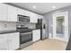 Modern kitchen with stainless steel appliances and white cabinetry, complemented by mosaic backsplash at 10211 Red Pueblo Pl # 203, Las Vegas, NV 89144