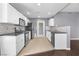 Well-lit kitchen featuring white cabinets, granite countertops, and stainless steel appliances at 10211 Red Pueblo Pl # 203, Las Vegas, NV 89144