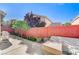 Private backyard featuring a paved area, beautiful trees, and brick perimeter wall at 10372 Timber Canyon Ave, Las Vegas, NV 89129