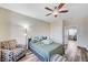 Well-lit bedroom with wood laminate flooring and comfortable sitting area at 10372 Timber Canyon Ave, Las Vegas, NV 89129