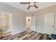 Bedroom with ceiling fan and neutral walls shows entry to another room with shower at 10372 Timber Canyon Ave, Las Vegas, NV 89129