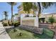 The Shadow Hills Club entrance featuring a stone sign with address, arched entry, and lush landscaping at 10372 Timber Canyon Ave, Las Vegas, NV 89129