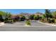 Gated community entrance with landscaped median and mountain views in the background at 10372 Timber Canyon Ave, Las Vegas, NV 89129