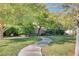 Neighborhood park featuring a curving walkway, mature trees, and picnic tables at 10372 Timber Canyon Ave, Las Vegas, NV 89129