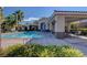 Community pool area with covered seating and palm trees on a sunny day at 10372 Timber Canyon Ave, Las Vegas, NV 89129