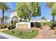 The Shadow Hills Club entrance showcases lush landscaping and architectural charm at 10372 Timber Canyon Ave, Las Vegas, NV 89129