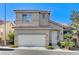 Inviting two-story home featuring a tile roof, attached two-car garage, and mature landscaping at 10372 Timber Canyon Ave, Las Vegas, NV 89129