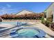 Relaxing spa with a bubbling hot tub, surrounded by lush greenery and a sparkling pool at 10372 Timber Canyon Ave, Las Vegas, NV 89129