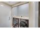 Laundry room boasts side-by-side washer and dryer, with butcher block folding table at 10372 Timber Canyon Ave, Las Vegas, NV 89129