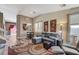 Cozy living room with a patterned rug, grey sofa set, and plenty of natural light at 10372 Timber Canyon Ave, Las Vegas, NV 89129