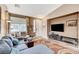 Spacious living area featuring a comfortable sofa, entertainment center, and natural lighting at 10372 Timber Canyon Ave, Las Vegas, NV 89129