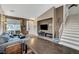 Open-concept living room featuring a staircase, comfortable seating, and entertainment setup at 10372 Timber Canyon Ave, Las Vegas, NV 89129