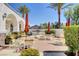 Inviting outdoor space features seating, umbrellas, mature landscaping, and a built-in grill area at 10372 Timber Canyon Ave, Las Vegas, NV 89129
