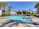 Community pool surrounded by palm trees, offering a relaxing oasis for residents at 10372 Timber Canyon Ave, Las Vegas, NV 89129