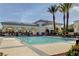 Relaxing community pool with a covered seating area, palm trees, and plenty of sunshine at 10372 Timber Canyon Ave, Las Vegas, NV 89129