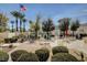 A beautiful pool area with comfortable seating, umbrellas and lush landscaping in the background at 10372 Timber Canyon Ave, Las Vegas, NV 89129