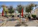 Inviting pool area features mature landscaping, an American flag, with shaded tables and seating at 10372 Timber Canyon Ave, Las Vegas, NV 89129