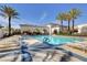 Inviting community pool with comfortable lounge chairs, perfect for soaking up the sun and enjoying the outdoors at 10372 Timber Canyon Ave, Las Vegas, NV 89129