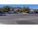 Street view of the gated community entrance with mountain views and desert landscaping at 10372 Timber Canyon Ave, Las Vegas, NV 89129