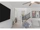 Comfortable living area with tile flooring, TV, and a staircase at 10376 Sadie Blake Ave, Las Vegas, NV 89166