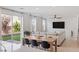 Bright living room with large windows, dining area, and backyard views at 10376 Sadie Blake Ave, Las Vegas, NV 89166