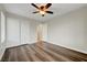 Bedroom with wood-look floors, ceiling fan, closet, and natural light at 10929 Vallerosa St, Las Vegas, NV 89141