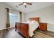 Bedroom with wood-look floors, ceiling fan and a large window providing natural light at 10929 Vallerosa St, Las Vegas, NV 89141