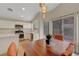 Open kitchen featuring white cabinetry and stainless steel appliances, next to the dining area at 10929 Vallerosa St, Las Vegas, NV 89141