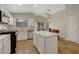 Modern kitchen featuring white cabinets, stainless steel appliances, a kitchen island, and tile flooring at 10929 Vallerosa St, Las Vegas, NV 89141