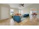 Spacious living room with tile flooring, an orange sofa, and large windows at 10929 Vallerosa St, Las Vegas, NV 89141