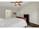 Spacious main bedroom featuring wood-look floors, ceiling fan and an arched doorway at 10929 Vallerosa St, Las Vegas, NV 89141