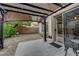 Relaxing covered patio with sliding glass door and decorative metal furniture, perfect for outdoor enjoyment at 10929 Vallerosa St, Las Vegas, NV 89141