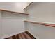 A well organized walk-in closet with shelves, rods and wood-look floors at 10929 Vallerosa St, Las Vegas, NV 89141
