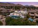 Expansive backyard with a sparkling pool, solar panels, and an outdoor dining area, perfect for entertaining with mountain views at 11453 Glowing Sunset Ln, Las Vegas, NV 89135