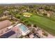 Aerial shot showcases backyard pool, spa, and the adjacent golf course, a golfer's dream at 11453 Glowing Sunset Ln, Las Vegas, NV 89135