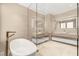 Modern bathroom with a soaking tub, floating vanity, and large mirrors at 11453 Glowing Sunset Ln, Las Vegas, NV 89135