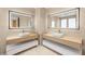 Modern bathroom featuring dual vanities with sleek fixtures and stylish mirrors at 11453 Glowing Sunset Ln, Las Vegas, NV 89135