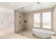 Spa-like bathroom featuring a soaking tub and a glass-enclosed shower at 11453 Glowing Sunset Ln, Las Vegas, NV 89135