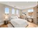 Serene bedroom featuring arched windows, wood floors, and neutral decor at 11453 Glowing Sunset Ln, Las Vegas, NV 89135