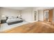 Spacious bedroom featuring a gray bed frame, neutral decor, and wood flooring at 11453 Glowing Sunset Ln, Las Vegas, NV 89135