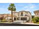 Elegant two-story home with brown roof, complemented by a well-manicured lawn and lush landscaping at 11453 Glowing Sunset Ln, Las Vegas, NV 89135