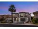 Stunning stucco home boasts a tile roof, well-manicured landscaping, and a tall palm tree enhancing its curb appeal at 11453 Glowing Sunset Ln, Las Vegas, NV 89135