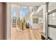 Bright foyer with a curved staircase, light wood floors, and large windows offering ample natural light at 11453 Glowing Sunset Ln, Las Vegas, NV 89135
